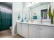 Well-lit bathroom with double vanity, ample cabinet space, and coordinated turquoise accents at 830 Club Chase Ct, Roswell, GA 30076