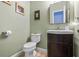 This clean bathroom features a toilet, a sink, and a mirror at 830 Club Chase Ct, Roswell, GA 30076