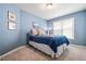 Serene blue bedroom with a comfortable bed and natural light from the window at 830 Club Chase Ct, Roswell, GA 30076