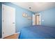 Cozy blue bedroom featuring a bed, carpeted floors, and ample natural light at 830 Club Chase Ct, Roswell, GA 30076