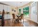 Sun-filled dining area features a large window overlooking the backyard and access to the patio at 830 Club Chase Ct, Roswell, GA 30076