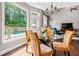 Dining area with a view of the pool and outdoor space, filled with natural light at 830 Club Chase Ct, Roswell, GA 30076
