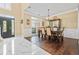 Elegant dining room featuring wood floors, a chandelier, and a large window providing natural light at 830 Club Chase Ct, Roswell, GA 30076