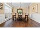 Dining room with hardwood floors, chandelier, and a large window providing natural light at 830 Club Chase Ct, Roswell, GA 30076
