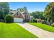 Exterior view of an attractive home with a driveway and a green front lawn at 830 Club Chase Ct, Roswell, GA 30076