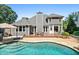 Back exterior with inviting pool and multiple seating areas perfect for gatherings at 830 Club Chase Ct, Roswell, GA 30076