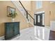 Bright foyer with marble floors, staircase with black railing, and elegant front door with glass panels at 830 Club Chase Ct, Roswell, GA 30076