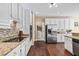 Modern kitchen featuring stainless steel appliances, granite countertops and access to laundry room at 830 Club Chase Ct, Roswell, GA 30076