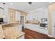 Open kitchen featuring stainless steel appliances, granite countertops, and white cabinets at 830 Club Chase Ct, Roswell, GA 30076