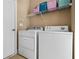 This laundry room has a washer, a dryer and storage space with shelving at 830 Club Chase Ct, Roswell, GA 30076