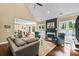 Spacious living room with a fireplace, comfortable seating, and an open view to the dining area at 830 Club Chase Ct, Roswell, GA 30076