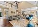 Bright living room featuring hardwood floors, area rug, and views into the kitchen with breakfast bar at 830 Club Chase Ct, Roswell, GA 30076