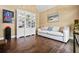 Comfortable living room with hardwood floors, a white bookshelf, and a cozy sofa at 830 Club Chase Ct, Roswell, GA 30076
