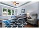 Relaxing primary bedroom with tray ceiling, blue accents, and backyard view at 830 Club Chase Ct, Roswell, GA 30076