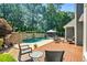 Inviting backyard features a pool, waterfall, stone wall, and comfortable seating at 830 Club Chase Ct, Roswell, GA 30076