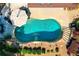 Backyard kidney shaped pool featuring stone waterfall and patio area at 830 Club Chase Ct, Roswell, GA 30076