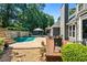 Beautiful backyard oasis with a pool, waterfall feature, and ample patio space at 830 Club Chase Ct, Roswell, GA 30076