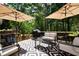 Outdoor deck area featuring patio furniture, a grill, and umbrella shade covers at 85 Eastwood Frst, Covington, GA 30014