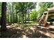 Large backyard featuring an outdoor deck, mature trees, and an outdoor seating area at 85 Eastwood Frst, Covington, GA 30014