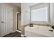 Relaxing bathroom with soaking tub, separate shower, and modern fixtures at 85 Eastwood Frst, Covington, GA 30014