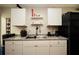 Modern kitchen with white cabinets, granite countertops, and stainless steel appliances at 85 Eastwood Frst, Covington, GA 30014