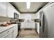 Well-lit kitchen featuring white cabinets, modern appliances, and functional layout at 85 Eastwood Frst, Covington, GA 30014
