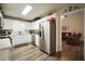 Spacious kitchen with stainless steel appliances, white cabinets, and open layout to living area at 85 Eastwood Frst, Covington, GA 30014