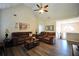 Inviting living room with a vaulted ceiling, ceiling fan, hardwood flooring, and comfortable seating at 85 Eastwood Frst, Covington, GA 30014