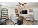 Comfortable living room with couches, a ceiling fan, and a large wall-mounted television at 85 Eastwood Frst, Covington, GA 30014