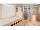 Bathroom with a tiled bath, glass enclosed shower, decorative trim, and a window for natural light at 10565 Highgate Manor Ct, Duluth, GA 30097