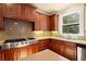 Kitchen featuring stainless steel appliances, wooden cabinets, and granite countertops at 10565 Highgate Manor Ct, Duluth, GA 30097
