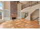 Elegant living space with vaulted ceilings, stone fireplace, built-in bookshelves and an open floor plan at 10565 Highgate Manor Ct, Duluth, GA 30097
