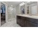 Spacious bathroom featuring a double vanity and glass-enclosed shower and walk-in closet for storage at 2432 Saint Patrick Se St, Atlanta, GA 30317