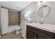 Well-lit bathroom with vanity, toilet, and tiled shower-tub combination, providing essential amenities at 2432 Saint Patrick Se St, Atlanta, GA 30317