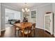 Bright dining room with hardwood floors, a wooden table, and views into the living room at 2432 Saint Patrick Se St, Atlanta, GA 30317