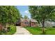 Brick home with a carport, driveway, landscaped yard, and a lush tree line at 2432 Saint Patrick Se St, Atlanta, GA 30317