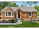 Charming brick home with a manicured lawn, inviting front entry, and a cozy seating area at 2432 Saint Patrick Se St, Atlanta, GA 30317