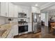 Stylish kitchen with stainless steel appliances, white cabinets, and hardwood floors at 2432 Saint Patrick Se St, Atlanta, GA 30317
