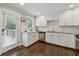 Updated kitchen with white cabinets, stainless steel appliances, and a door to the outdoor deck at 2432 Saint Patrick Se St, Atlanta, GA 30317