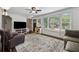 Inviting living room featuring a large window, hardwood floors, and a comfortable sofa at 2432 Saint Patrick Se St, Atlanta, GA 30317