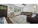 Bright living room with hardwood floors, large windows, and comfortable seating arrangements at 2432 Saint Patrick Se St, Atlanta, GA 30317