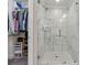 The glass-enclosed shower features stylish tile and modern fixtures and an adjacent walk-in closet at 2432 Saint Patrick Se St, Atlanta, GA 30317