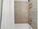 The tiled tub and shower with a white shower curtain creates a relaxing spa-like atmosphere at 2432 Saint Patrick Se St, Atlanta, GA 30317