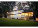 Expansive backyard with lush green grass, exterior stairs and well-lit windows at 1155 Peachtree Battle Nw Ave, Atlanta, GA 30327