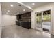 Basement bar area with custom cabinetry, shelving and beverage fridge at 1155 Peachtree Battle Nw Ave, Atlanta, GA 30327
