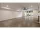 Finished basement area with concrete floors, fireplace and walkout to patio at 1155 Peachtree Battle Nw Ave, Atlanta, GA 30327
