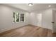 Well-lit bedroom featuring a window with backyard views and an en-suite bathroom at 1155 Peachtree Battle Nw Ave, Atlanta, GA 30327