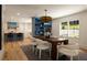 Dining room with hardwood floors, modern lighting, and built in cabinets, open to the kitchen at 1155 Peachtree Battle Nw Ave, Atlanta, GA 30327