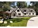 Stunning two-story home featuring a modern painted brick facade and professionally landscaped front yard at 1155 Peachtree Battle Nw Ave, Atlanta, GA 30327