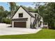 Spacious exterior view of home with a garage, staircase, and lush lawn at 1155 Peachtree Battle Nw Ave, Atlanta, GA 30327